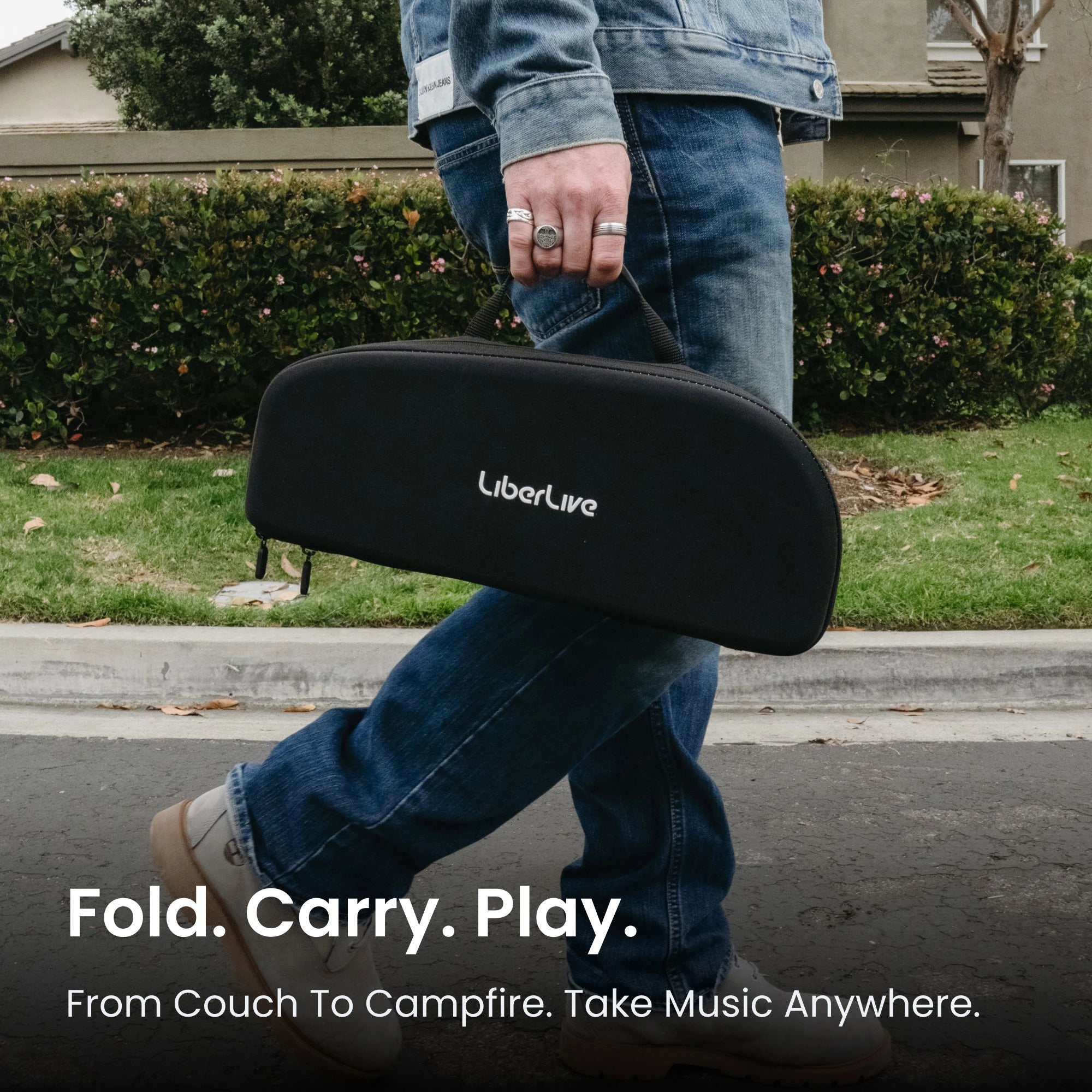 LiberLive C1 travel case carried outdoors, highlighting the foldable smart guitar for portable playing.