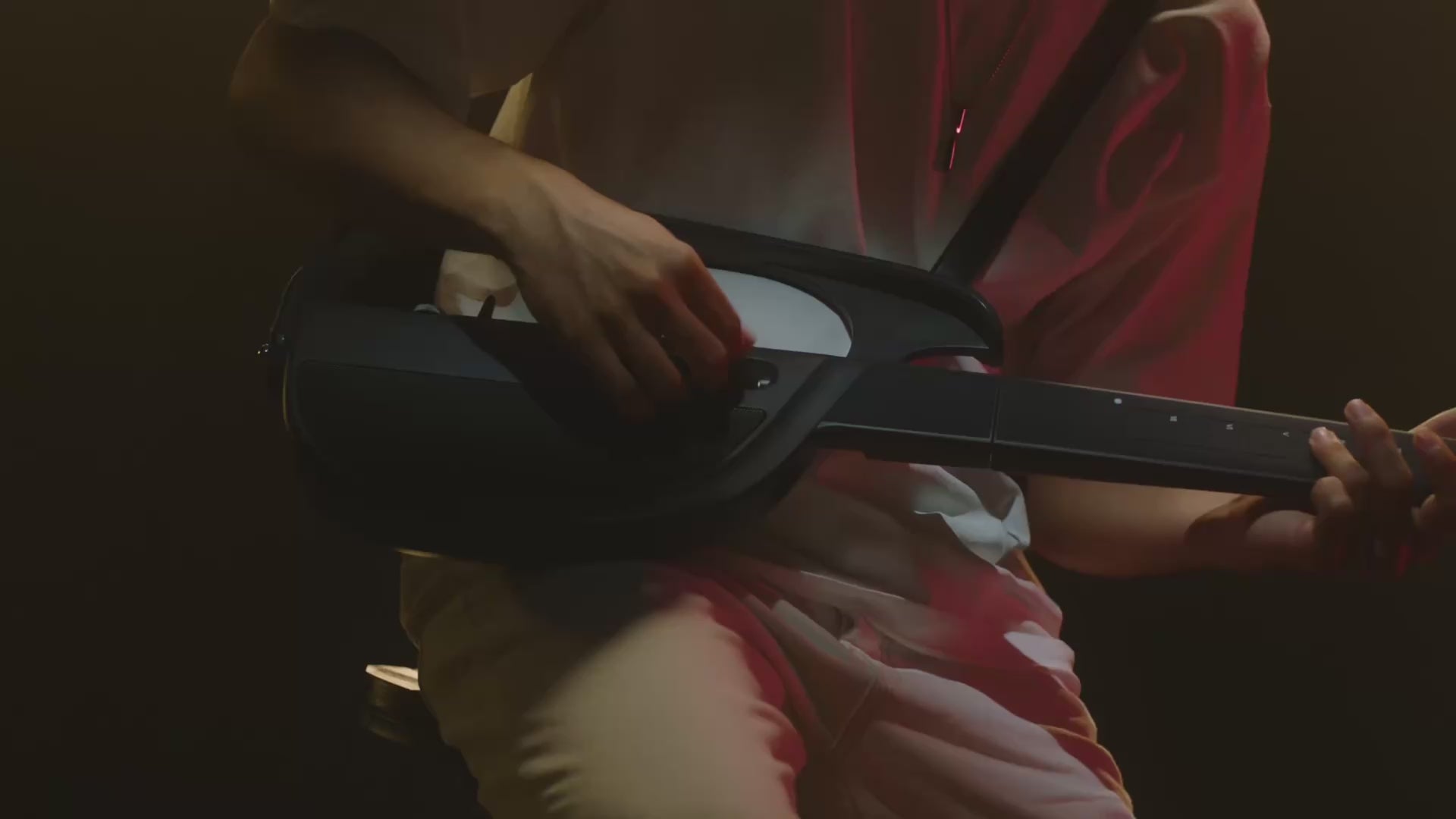 Load video: Close-up video of a person performing with a black LiberLive C1 stringless smart guitar.